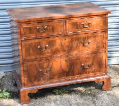 An Georgian walnut and crossbanded chest of two short and two long drawers on bracket feet, width