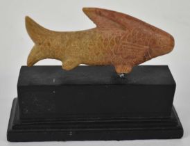An Egyptian carved soapstone figure of a fish, length 11cm, mounted on ebonised base.