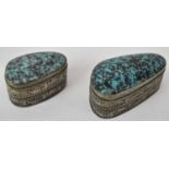 Two Persian white metal pill boxes inset with turquoise, the larger 6cm.