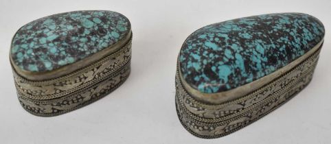 Two Persian white metal pill boxes inset with turquoise, the larger 6cm.