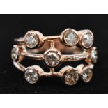 A 9ct rose gold scaffold style ring bubble-set with scattered diamonds, boxed, approx. 1.35ct.