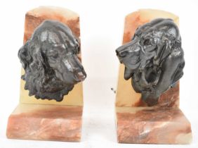 A pair of decorative spelter and alabaster dog bookends, height 20cm.