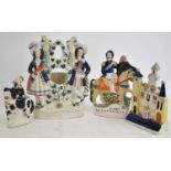 A group of four Staffordshire figures including a pocket watch holder, height 26.5cm (4).