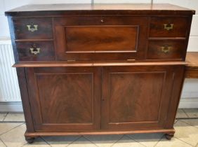 A large 19th century mahogany campaign style secretaire chest with central fall front flanked by two