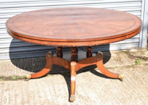 A large reproduction Regency style circular dining table with circular segmented and crossbanded