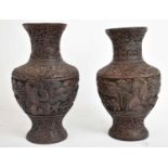 A pair of Chinese cinnabar type vases of baluster form, height 22.5cm (af). Condition Report: Both