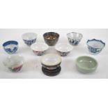 A group of predominantly Chinese ceramics, mainly tea bowls including a near pair of blue and