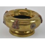 A brass Chinese style ashtray, decorated with four coppered Buddhas and set with four hardstones,