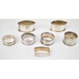 A pair of George V hallmarked silver napkin rings, Birmingham 1929, together with five other various