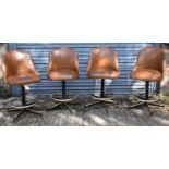 MICHIGAN TUBE SWAGERS; a set of four contemporary leather upholstered revolving bar stools.