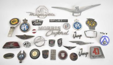 A collection of vintage car and motoring badges including AA, RAC, The Vintage Sports Car Club, Ford