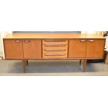 G-PLAN; a long rectangular teak sideboard, with four central drawers flanked by pairs of doors,
