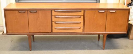 G-PLAN; a long rectangular teak sideboard, with four central drawers flanked by pairs of doors,