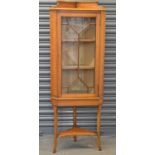 An Edwardian satinwood and crossbanded free standing corner cupboard, height 150cm (currently