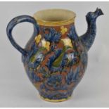 DELLA ROBBIA; a late 19th century jug with floral decoration and mask spout, height 24cm (af).