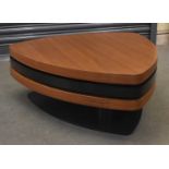 A stylish contemporary coffee table composed of three swivel-out tiers in simulated teak and black