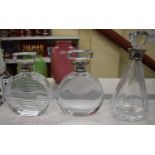 Two Art Deco style crystal decanters of circular form with white metal mounts, height 23.5cm and