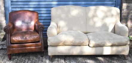An upholstered sofa on turned supports, also a modern leather armchair (2).