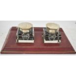 A leather inkstand with pair of silver mounted inkwells for London 1943, width 26cm.