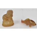 A small carved agate Dog of Fo, height 5cm (af), also a small agate fish.