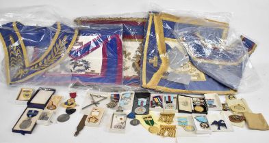 A black leather case of approx. ten Masonic aprons and badges, also medals.