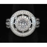 A large silver dinner ring set with multiple cubic zirconia, size P.