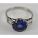 A platinum ring set with large blue central stone, size P, 4.5g.