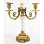 An early 20th century French gilt metal and cut glass three-branch candelabrum, formerly a lamp,