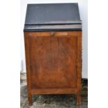 A rare early 20th century compositor's desk with sloping steel top above fifteen side drawers and