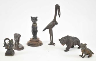 A group of bronze, spelter and metal animal figures including crane, pug dog, opium weight, buffalo,