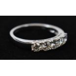An 18ct white gold five stone diamond ring, combined approx. 0.75ct, size M/N.