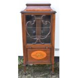 An Edwardian inlaid mahogany music cabinet, the lyre decorated glazed door above a fall front, width