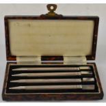 A cased set of four sterling silver propelling pencils, length 9cm.