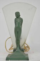 An Art Deco green patinated metal figural lamp with figure of a standing young female, a frosted fan