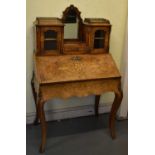 A Victorian walnut and marquetry inlaid bureau in the French style, the upper section with central