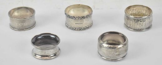 A group of five hallmarked silver napkin rings, four Birmingham and one London 1886, combined