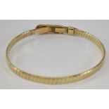 A 9ct yellow gold bangle, approx. 13.1g.