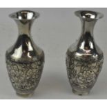 A pair of Chinese Export silver baluster form vases decorated with birds amongst foliage, incised