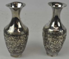 A pair of Chinese Export silver baluster form vases decorated with birds amongst foliage, incised