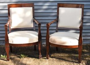 A pair of Continental mahogany framed Empire style open arm elbow chairs with upholstered backs