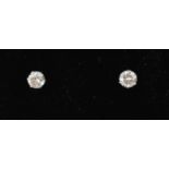 A pair of 18ct white gold diamond solitaire ear studs, approx. 0.20ct, boxed.