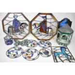 A collection of ten stained glass panels and two stained glass lanterns.