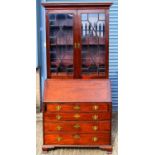 A 19th century mahogany bureau bookcase, the upper section with pair of astragal glazed doors