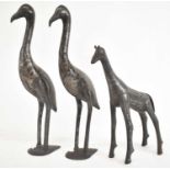 A pair of Moroccan damascene metal figures of storks, height 42cm and a giraffe height 31.5cm.