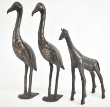 A pair of Moroccan damascene metal figures of storks, height 42cm and a giraffe height 31.5cm.