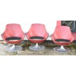 A set of stylish contemporary red leather barrel shaped swivel chairs on metal bases, in need of
