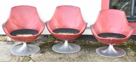 A set of stylish contemporary red leather barrel shaped swivel chairs on metal bases, in need of