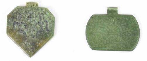 Two Persian green hardstone pendants with incised decoration, the taller height 6cm.