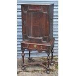 An antique oak cupboard, 18th/19th century, the door (af) enclosing a fitted interior of eleven