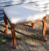 A reproduction mahogany French style dressing table stool with upholstered top.